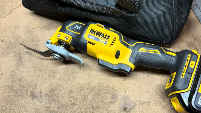 View of a DeWalt cordless multi-tool on a table next to a black case