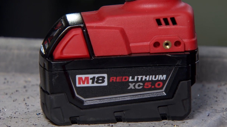 Closeup of M18 red lithium XC 5.0 battery on a cloth surface