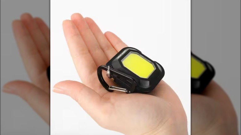 person holding Defiant utility light