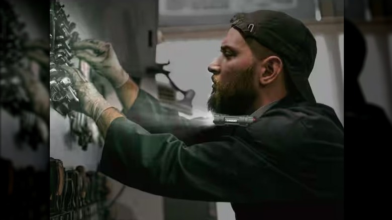 man wearing Husky neck light while working