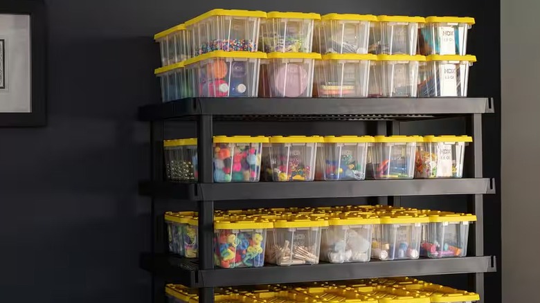 HDX 6.5-Qt Tough Storage Tote in Clear with Yellow Lid stacked in black plastic shelf unit