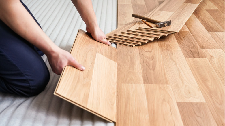 man installing wood floor