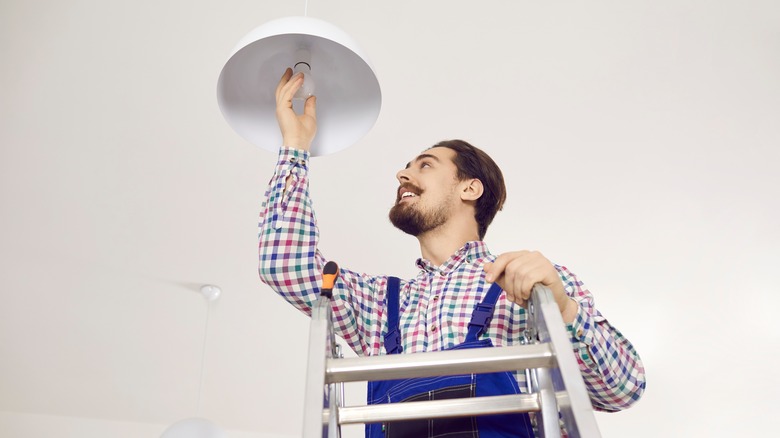 man changing lightbulb