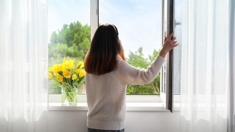 Woman looking out window