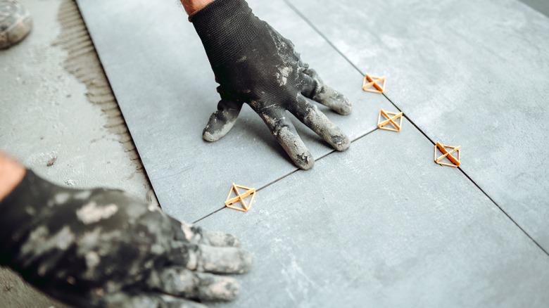 Person installing tile