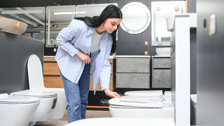 A person shopping for a new toilet