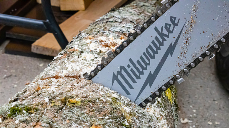 Milwaukee brand blade cutting a log
