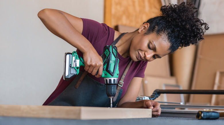 Woman using drill