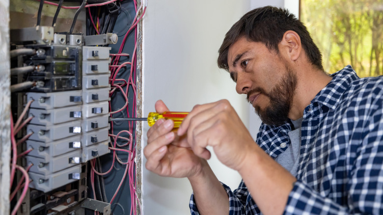 Man doing electrical work with screwdriver