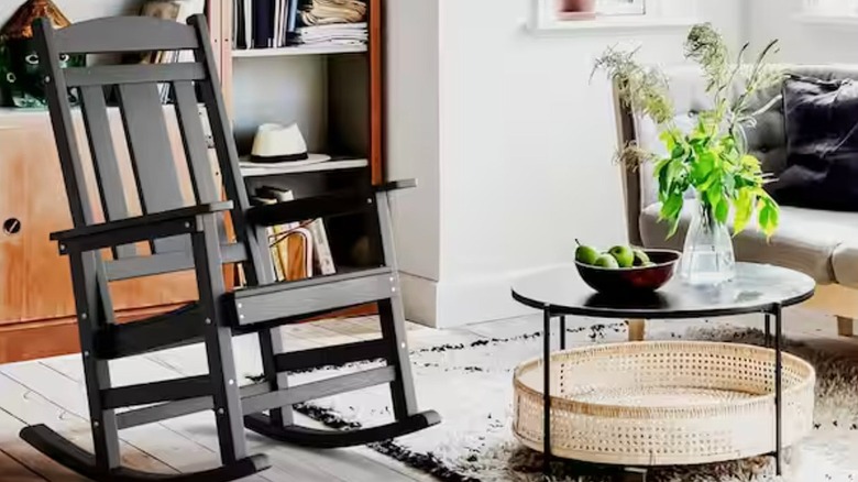Black Adirondack outdoor rocking chair in a living room