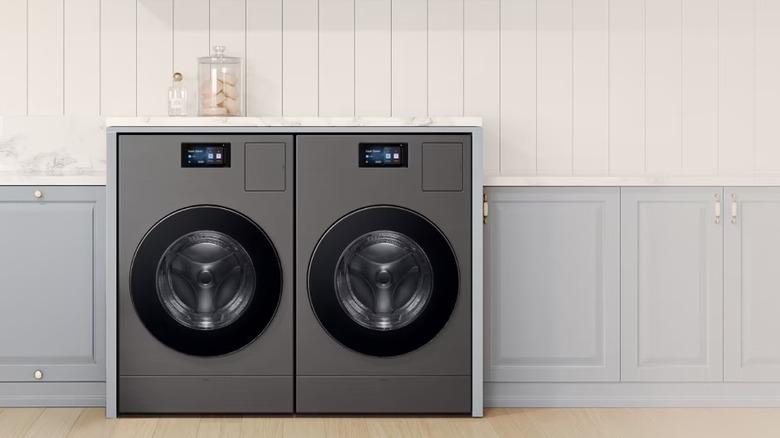 Two vented washer and dryer combos in a laundry room