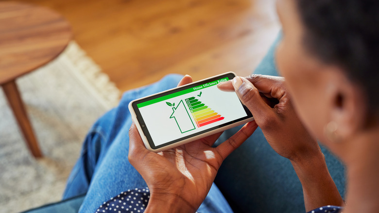 A woman uses a home efficiency calculator to determine where to save money