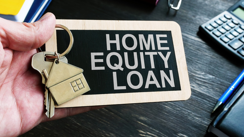 Handheld home equity loan sign