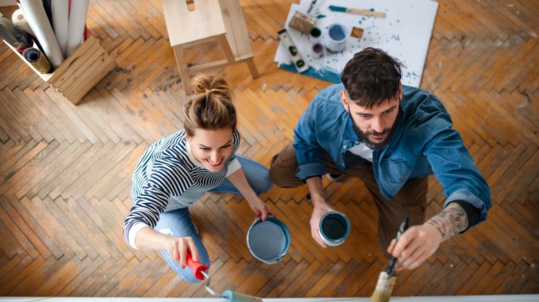 Young couple painting home interior 