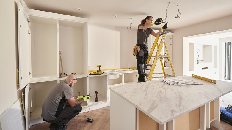 Couple working on kitchen remodel 