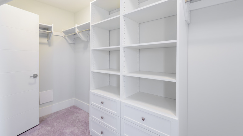 A walk-in closet with a built-in organizer