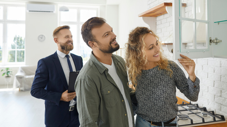 People looking at cabinets with realtor