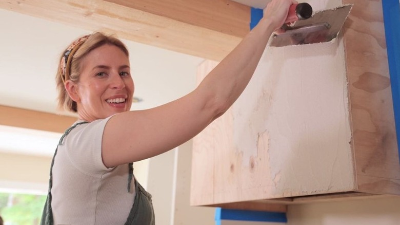 Erin Napier applying plaster to wall