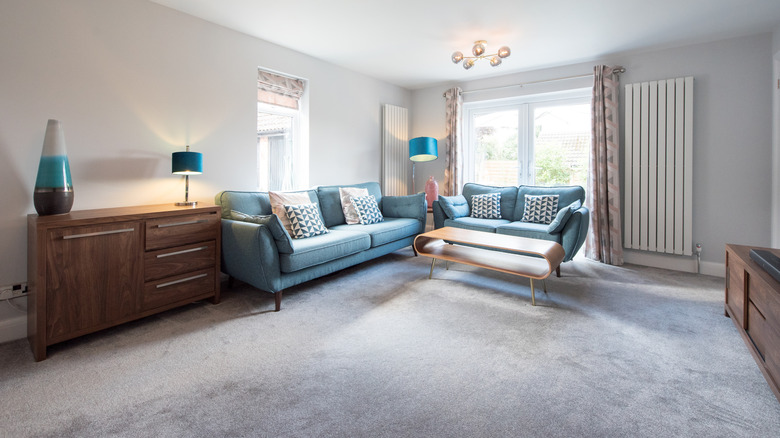 A living room with wall-to-wall carpet