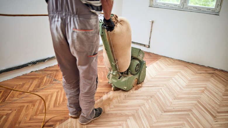 A repairman restoring parquet floors.