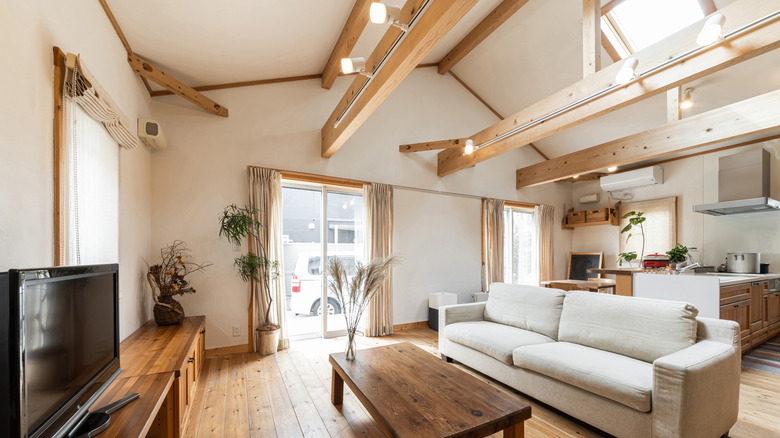 A living room with wood beams.