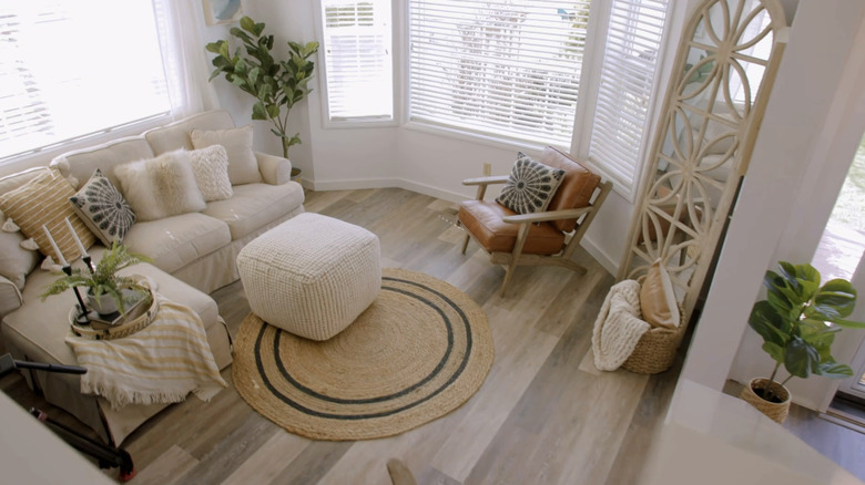 Ariel view of living room with white couch and round jute rug