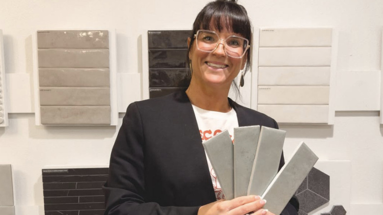 Lyndsay Lamb smiling and holding tile samples