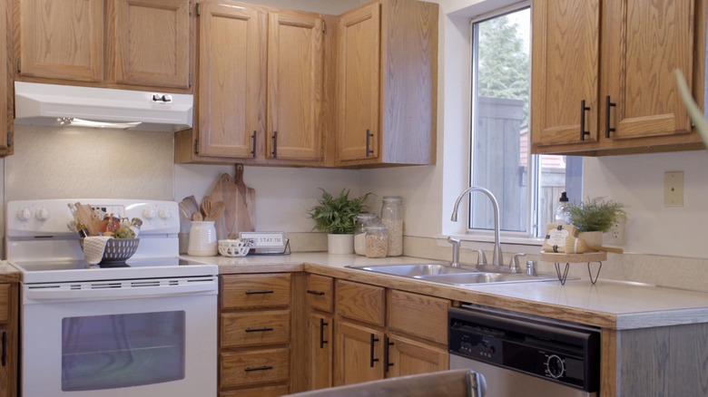 Kitchen with light cabinets and black hardware