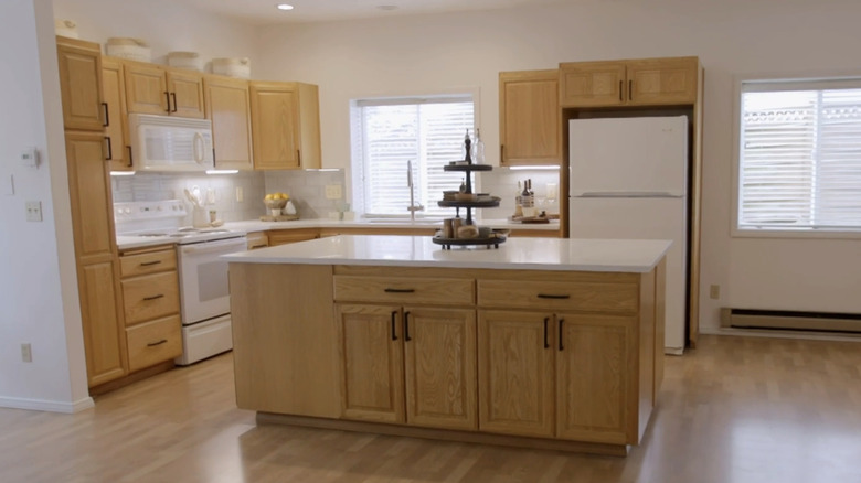 Updated kitchen with light cabinets and dark pulls