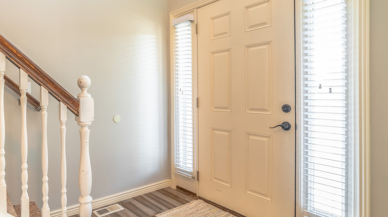 bland entryway with white front door and plain wall
