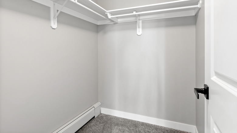 Empty closet with white shelves