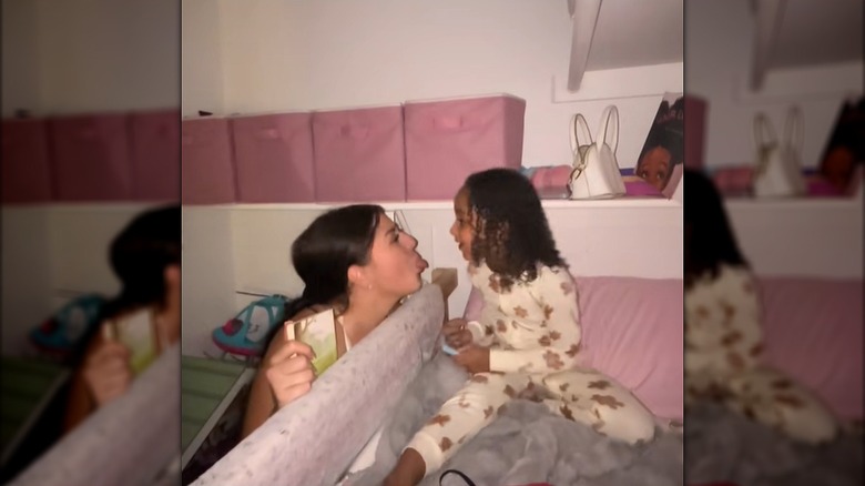 A mom acts silly with her daughter at bedtime.