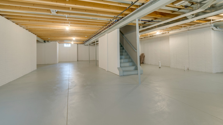 Bare unfinished basement with gray flooring