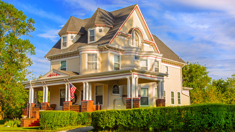 A victorian-style home during a bright day with blue skies