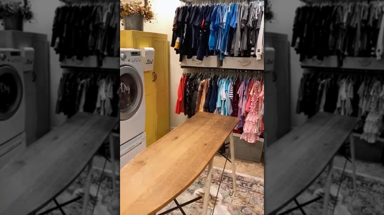 Laundry room with racks for kids and husbands clothes