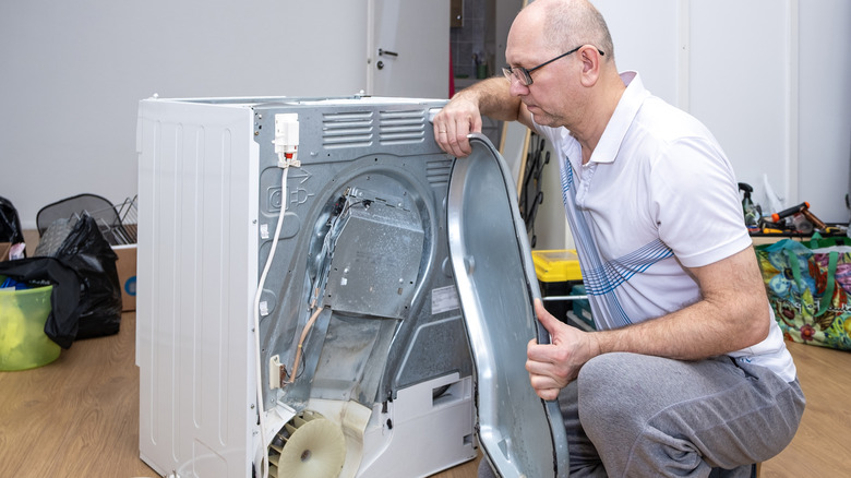 Man taking a dryer apart