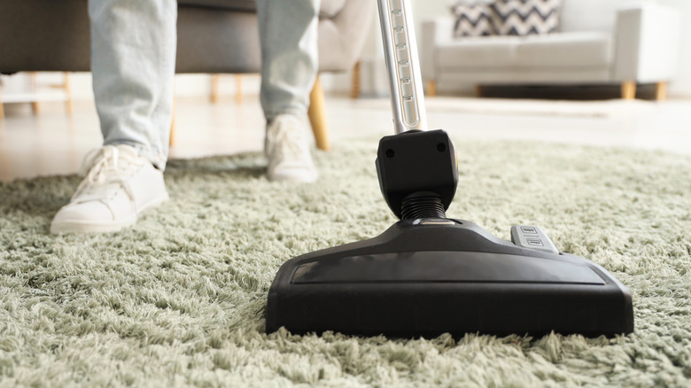 Close-up of somebody cleaning a carpet with a vacuum cleaner