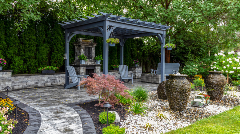 A beautifully landscaped garden and patio with blue pergola