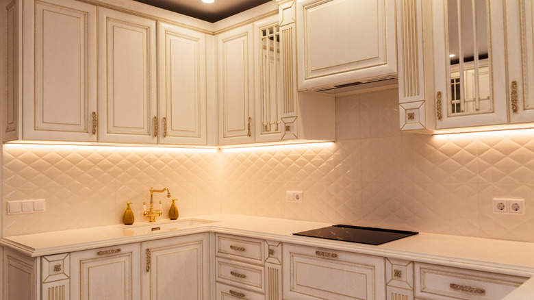 An elegant white kitchen with under-cabinet lighting
