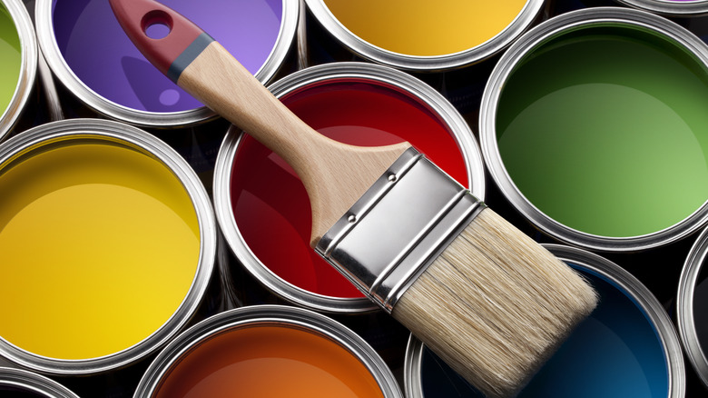 colorful paint cans with a paint brush