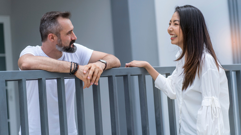 neighbors chatting over fence