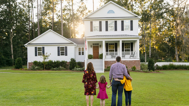 Family looking at house