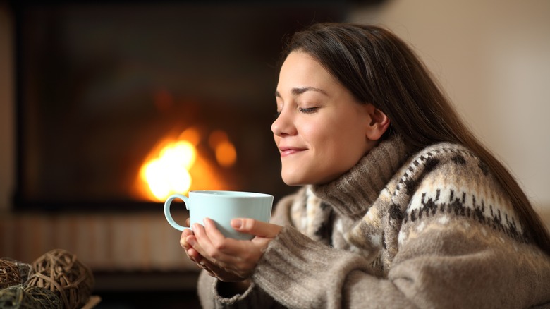 Woman in front fireplace