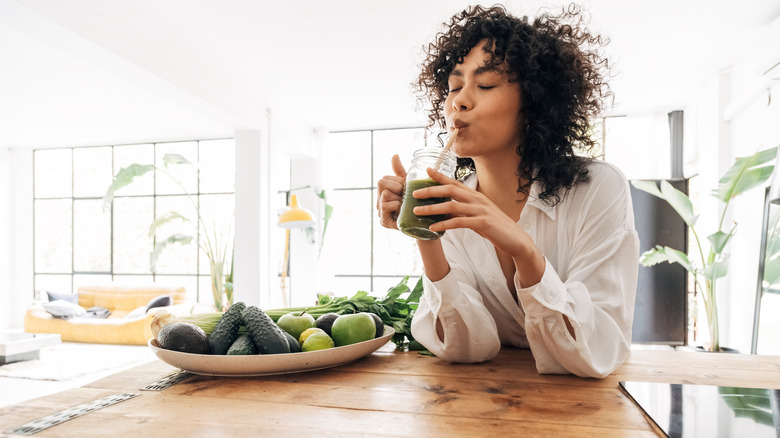 african american woman drinking juice