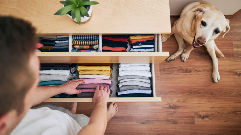 man opening drawer folded underwear