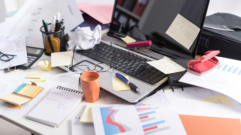 desk cluttered in paper