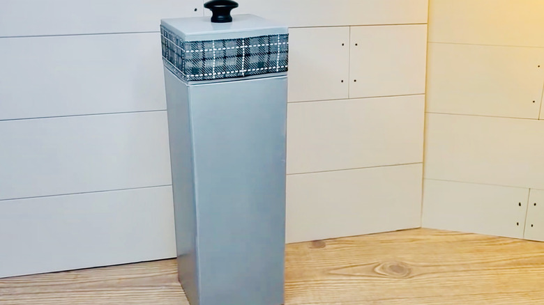 Wine box repurposed into plastic-bag storage sits on counter prior to being wall-mounted.