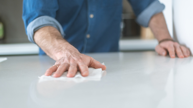 person cleaning countertop