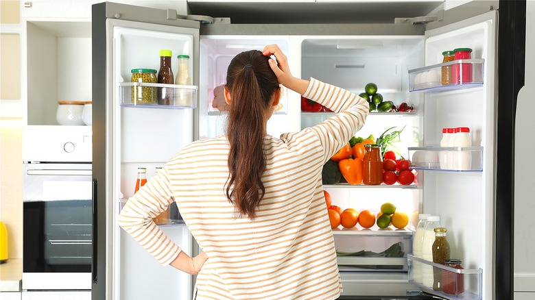Person checking refrigerator