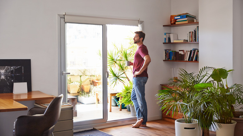 man standing by sliding door